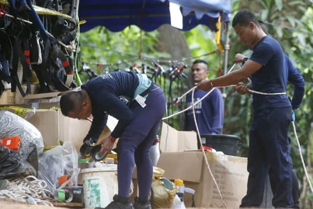 Thai rescuers prepare to enter the cave where 12 boys and their soccer coach have been trapped since June 23, in Mae Sai, Chiang Rai province, in northern Thailand Friday, July 6, 2018. (AP Photo/Sakchai Lalit)