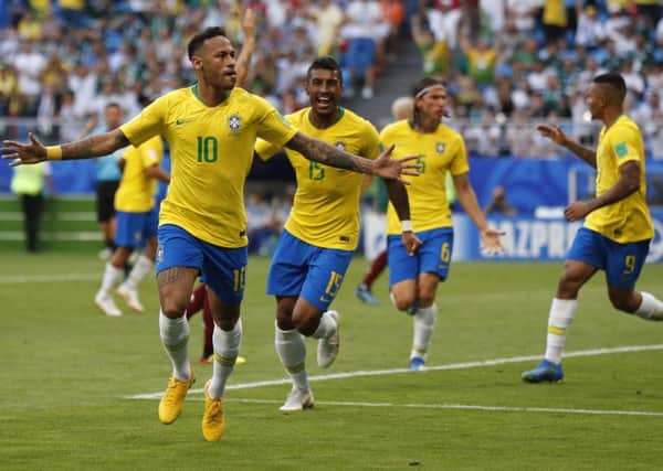 Brazil's Neymar celebrates after scoring his side's opening goal during the round of 16 match between Brazil and Mexico