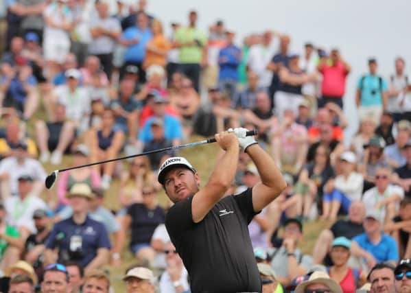 Graeme McDowell tees off to a full gallery on the 8th