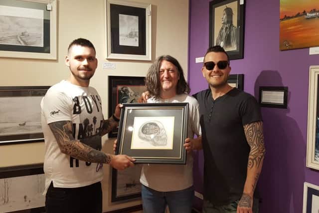 Fergie pictured with Carl and the owner of Trends Framing, Dick Tracey.