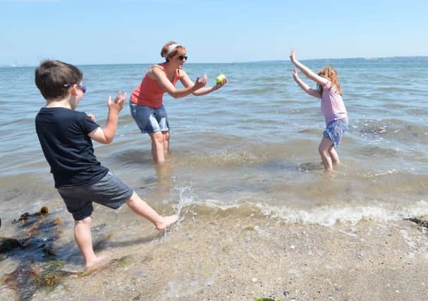 Jennifer Solomon with Grace Kelly and William Surgenor cooling down in the sea at Hazelbank Park during the sizzling summer weather. Pic by Colm Lenaghan/Pacemaker