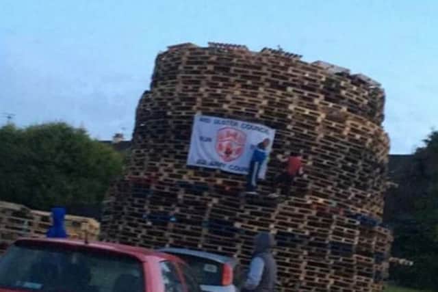 Flag being put up on Eleventh Night bonfire
