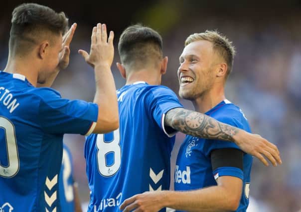 Rangers Scott Arfield (right) celebrates with Rangers Ryan Jack (8) and Glenn Middleton after scoring during a pre-season friendly