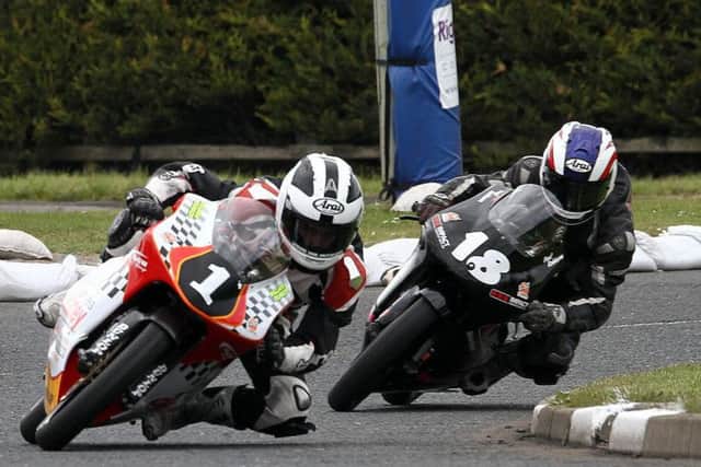 William Dunlop leads his cousin Paul Robinson at the North West 200 in 2010.