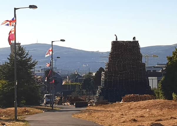 Bloomfield Walkway bonfire in east Belfast on Monday evening after Belfast City Council asked bonfire builders to reduce its size. Pic by PA/PA Wire