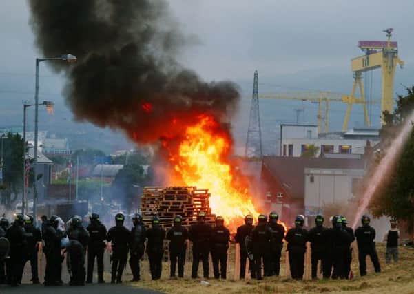 The scene at Bloomfield Walk bonfire in east Belfast, which was set on fire during the night. A High Court order late on Tuesday night stated that the bonfire should be reduced in size as it was a danger to surrounding homes. Picture by Jonathan Porter/PressEye