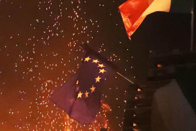 An EU flag is burned on an 11th night Bonfire in the Sandy Row area of Belfast