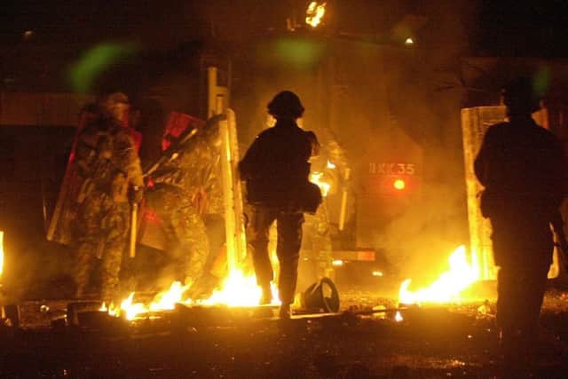 Soldiers come under attack from a loyalist mob in the Ardoyne area of north Belfast near the Holy Cross Primary School in 2001