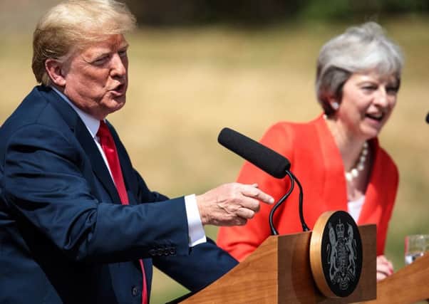 Theresa May, pictured here with Donald Trump during his UK visit last week, has been urged to be more like the US president in her negotiations with the EU