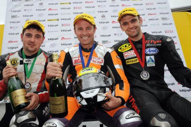 Race winner Ian Lougher with runner-up William Dunlop (right) and his brother Michael following the 125cc race at the Ulster Grand Prix in 2008.