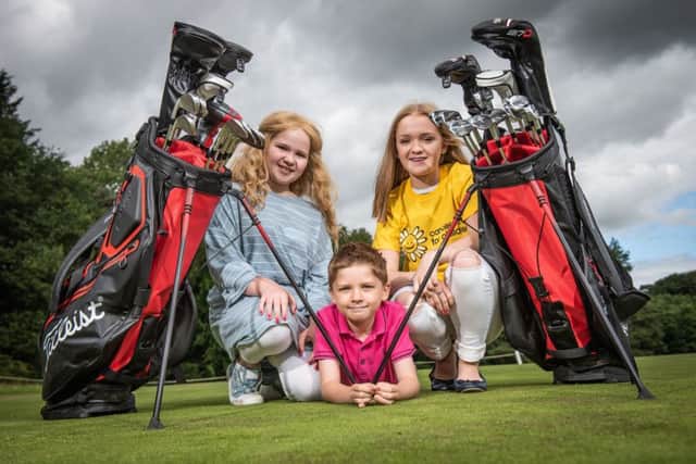 Molly (12), Ellie (14) and Matthew (8) Taylor, from Ahoghill, who received support from the charity during Mollys cancer diagnosis, announce the exciting news.