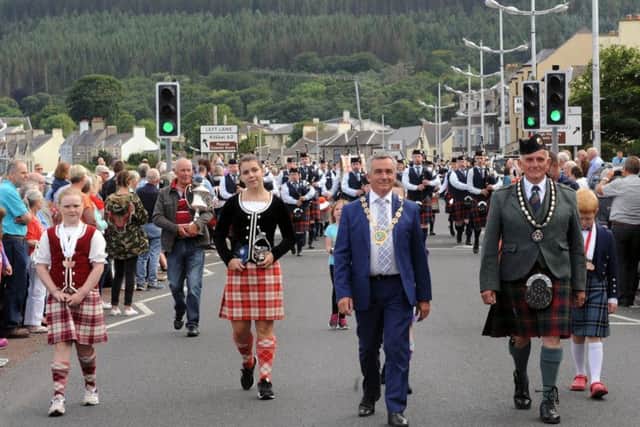 Newry, Mourne and Down Council Chairperson Mark Murnin leading the parade along Newcastle Main Street after the Ulster Championships along with Winston Pinkerton [RSPBA NI branch president] and highland dancers Rebekah Murdock [Newtownards] and Rebecca Srebot [Canada]