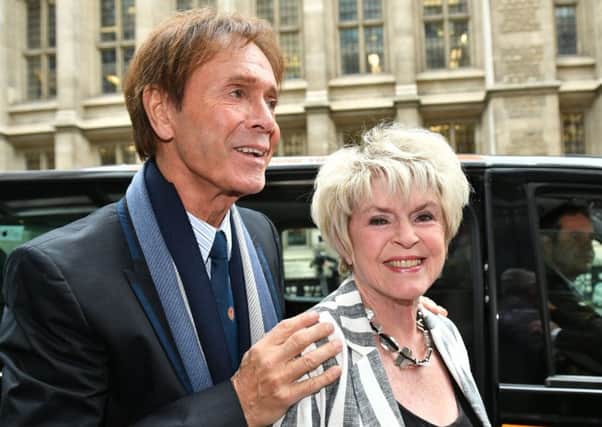 Sir Cliff Richard arrives with Gloria Hunniford at the Rolls Building in London, to give evidence in a legal battle against the BBC. Dominic Lipinski/PA Wire