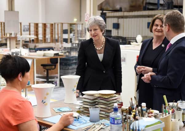 PM Theresa May (centre) and Arlene Foster the leader of the DUP during a visit to Belleek pottery factory on the northern side of the border between Enniskillen and Ballyshannon in Donegal. PRESS ASSOCIATION Photo. Clodagh Kilcoyne/PA Wire