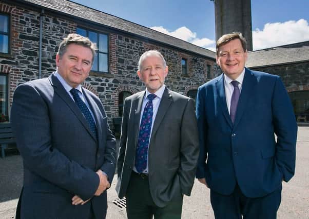 Brian Irwin, centre, is welcomed to the post by outgoing chairman Declan Billington, left, and executive director Michael Bell