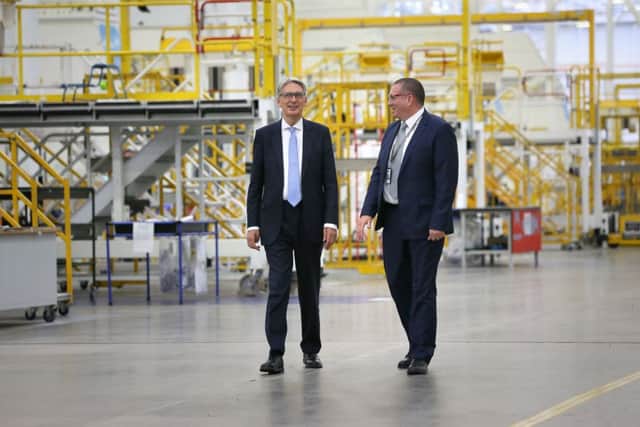 Chancellor of the Exchequer Phillip Hammond (left) with Jonathan Connell, vice president of operations, during his visit to the Bombardier factory in Belfast