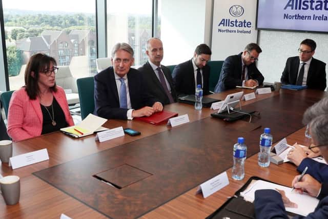Chancellor of the Exchequer Phillip Hammond (second left) attends a financial services roundtable meeting with business leaders at Allstate in Belfast. Photo: Brian Lawless/PA Wire