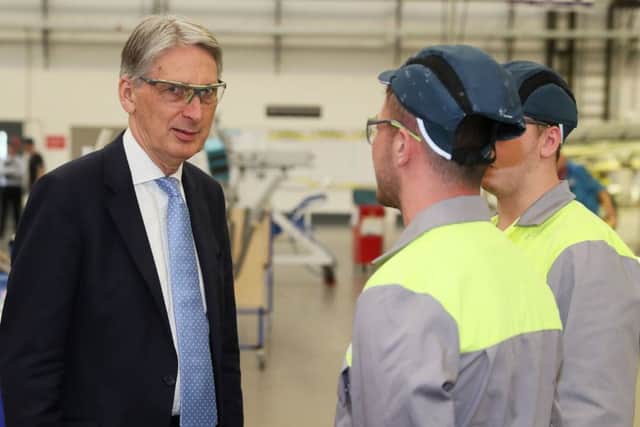 Chancellor of the Exchequer Phillip Hammond meets apprentices during a visit to the Bombardier factory in Belfast on Wednesday July 25, 2018. Photo: Brian Lawless/PA Wire