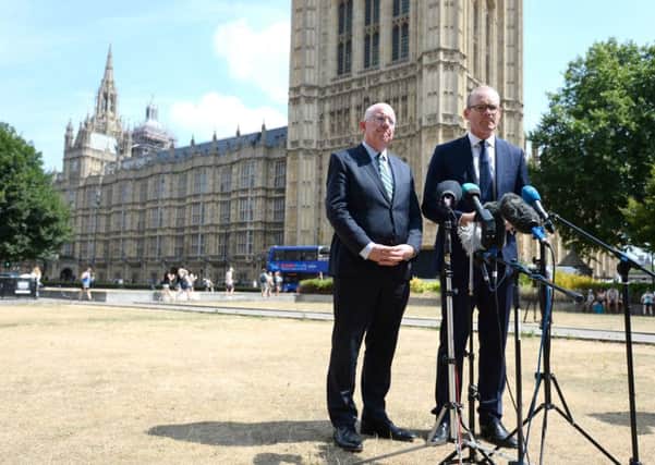 Simon Coveney, right, and Charlie Flanagan speaking to the media in Westminster yesterday. Photo: Kirsty O'Connor/PA
