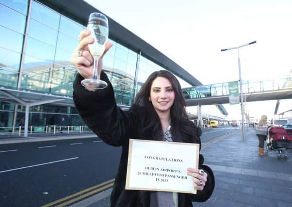 Dublin airport has developed in a way that it gets many Northern Irish passengers. Roma Chang, above, from Donaghmore Co Tyrone in 2013 was the 20 millionth passenger to walk through the doors of Terminal 2, three years after it opened. Leon Farrell/Photocall Ireland.