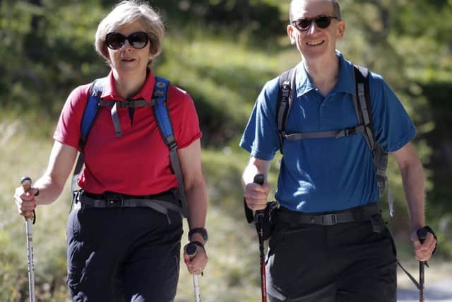 This summer will be less relaxed for the two main party leaders than previous summers: above, the prime minister Theresa May and her husband Philip walking in Switzerland in August 2016. Photo: Marco Bertorello/PA Wire