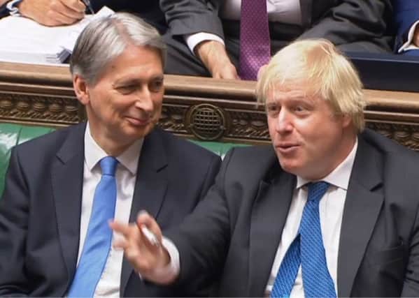 Chancellor Philip Hammond (left) and the then Foreign Secretary Boris Johnson  in the House of Commons last month. Mr Hammond is seen as one of the most sceptical politicians about Brexit, while Mr Johnson resigned from the cabinet because he felt Brexit was betrayed by the Chequers plan. Photo: PA Wire