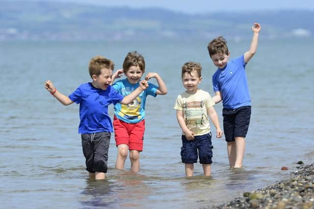 Daniel Murray, River Hewitson-Freeman,Tom and Danny Beattie from Belfast yesterday at Holywood beach, enjoying what will probably be the last warm weather for several days.
Picture By: Arthur Allison Pacemaker.