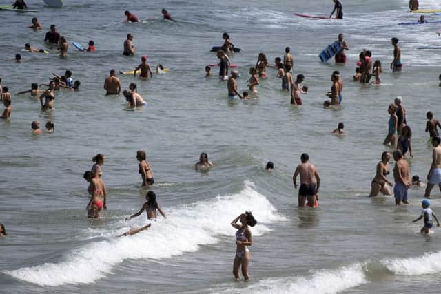 People enjoy the sea at Biarritz beach, southwestern France, Wednesday, July 25, 2018, which reached 26 Celsius (79F), not far above Giant's Causeway, which was 25C the same day. (AP Photo/Bob Edme)