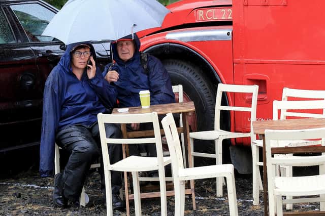 Fans take shelter from the rain at the Armoy Road Races on Saturday.