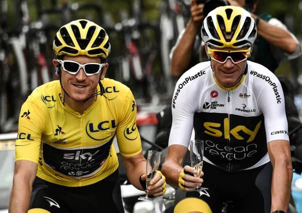Geraint Thomas and Christopher Froome hold a glass of champagne