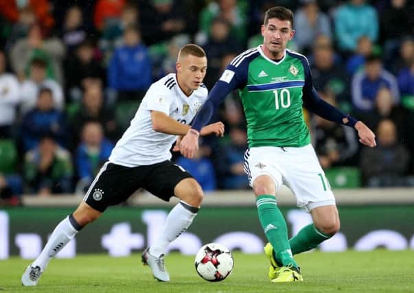 Northern Ireland's Kyle Lafferty with Germany's Joshua Kimmich