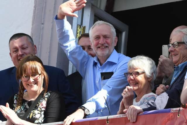 A content looking Labour Party leader Jeremy Corbyn enjoys the Durham Miners Gala last summer, July