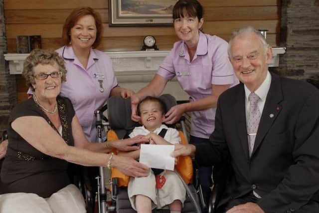 2009: Dale Eakin and his grandmother May, pictured handing over a cheque for Â£1,000.00, proceeds from various fundraising events held in memory of David Eakin, to Dr. Tom McGinley, Director of the Foyle Hospice. included are Staff Nurse Patricia O'Connor and Staff Nurse Teresa McGowan. LS31-121KM