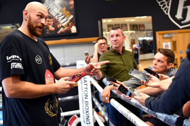 Tyson Fury speaks to media during a workout at Hatton Health and Fitness