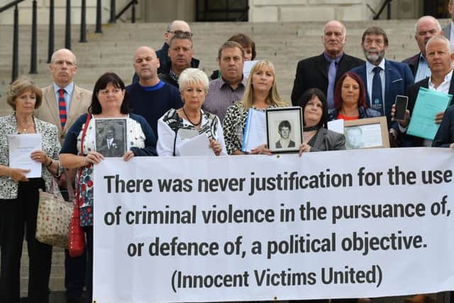 Victims of the IRA on the steps of Stormont hold their HET reports into the murder of their loved one, which they believe did no bring them justice, before an event held inside on legacy on Monday evening. Pic Colm Lenaghan/Pacemaker