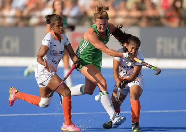 India's Sunita Lakra and Neha Goyal foul Nicola Evans of Ireland in the Vitality Hockey Women's World Cup quarter-final. Pic by INPHO.