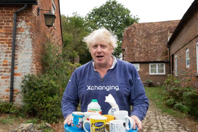 Boris Johnson brings tea for the press to drink outside his house in Thame on Sunday but refuses to speak about the burka row. Photo: Aaron Chown/PA Wire