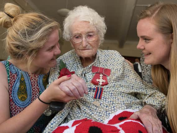 Britain's longest-serving poppy seller, 103-year-old Rosemary Powell, with grand daughters Emma Powell (left) and Rachel Powell, after she was presented with an MBE at her retirement home in west London by Vice Lord-Lieutenant of Greater London, Colonel Jane Davis