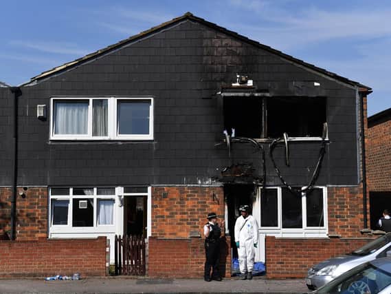 Police and forensics officers at the scene of a house fire on Adolphus Street, Deptford, south-east London, in which a seven-year-old boy has died.