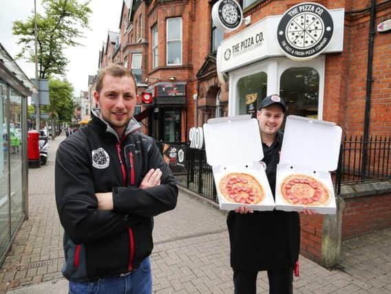 Martin Conlon, co-owner of The Pizza Co and The Chip Co, is pictured with manager of The Pizza Co in Botanic, Matthew Stevenson, as it is announced that Northern Irelands largest independent fast food group will create 60 new jobs over the next three months
