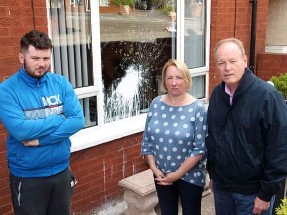 DUP of (left to right) Councillor Dale Pankhurst, Janice Beggs of Lower Oldpark Community Association and William Humphrey MLA, at a property on Manor Street that was targeted in an overnight paint bomb attack, which is being treated as a sectarian hate crime