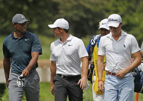 Tiger Woods (left), Rory McIlroy and Justin Thomas walk to the eighth fairway during the first round of the PGA Championship at Bellerive Country Club. Pic by AP Photo/Jeff Roberson.