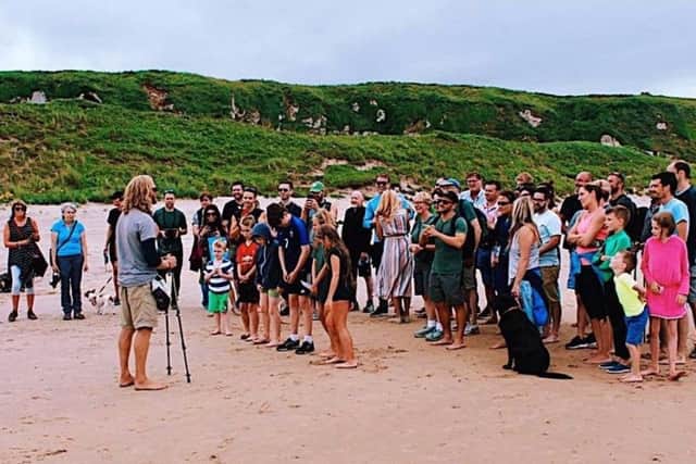 Stephen Bell is greeted by friends and family at Whitepark Bay beach