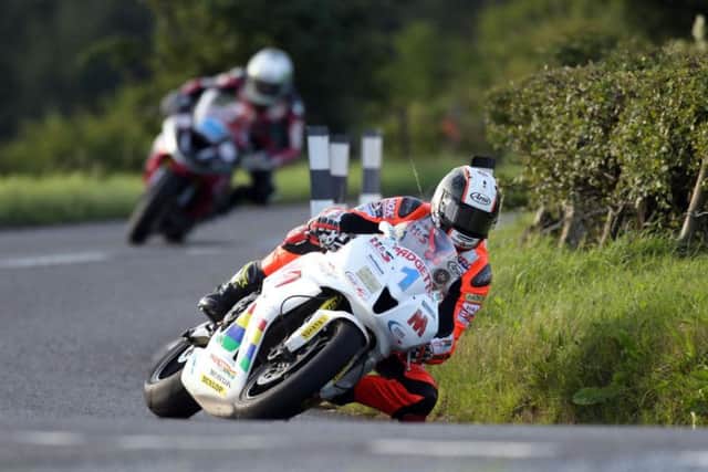 Conor Cummins (Padgett's Honda) leads Adam McLean (McAdoo Kawasaki) in the opening Supersport race at the MCE Ulster Grand Prix on Thursday.