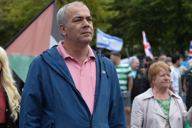 Lurgan republican Colin Duffy watches Saturday's anti-internment parade. 
Photo by Pacemaker Press