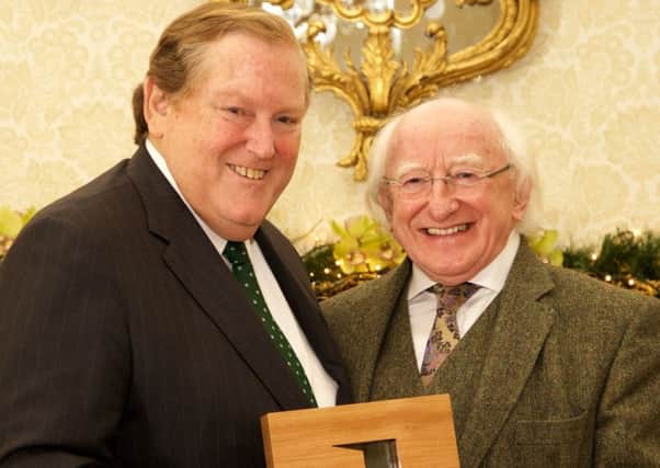 The late Dr Tom Moran (left), who was chancellor of Queen's University Belfast, receives the Irish Presidential Distinguished Service Award for his work on peace and reconciliation and development, from President Michael D Higgins