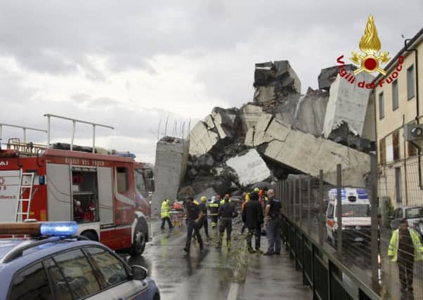 This photo released by the Italian firefighters, rescuers work among the rubble of the collapsed Morandi highway bridge in Genoa, northern Italy. (Vigili Del Fuoco via AP)
