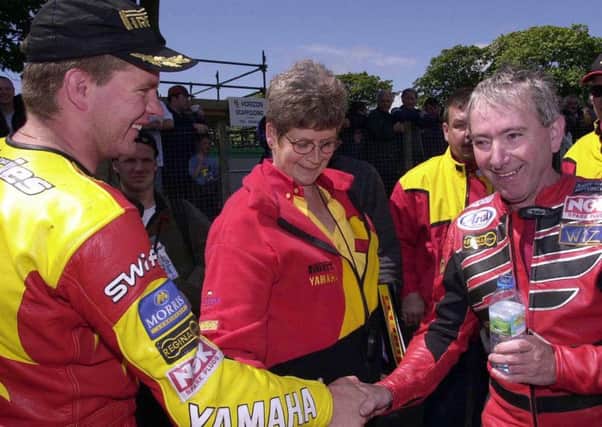 Both treble winners at the Isle of Man TT in 2000, Joey Dunlop, right, congratulates David Jefferies in the winners enclosure. Both were later killed in crashes