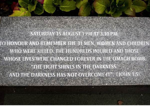 The Omagh bomb engraving at the site of the explosion that uses much more mild wording about the attack than another inscription in the remembrance garden