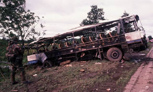 A soldier surveys the aftermath of he IRA attack on an army bus at Ballygawley, Co Tyrone, which killed eight of his colleagues and injured 19 others on 20 August 1988. Photo: Pacemaker